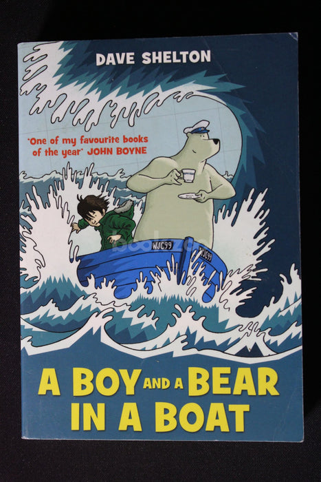 A boy and a bear in a boat